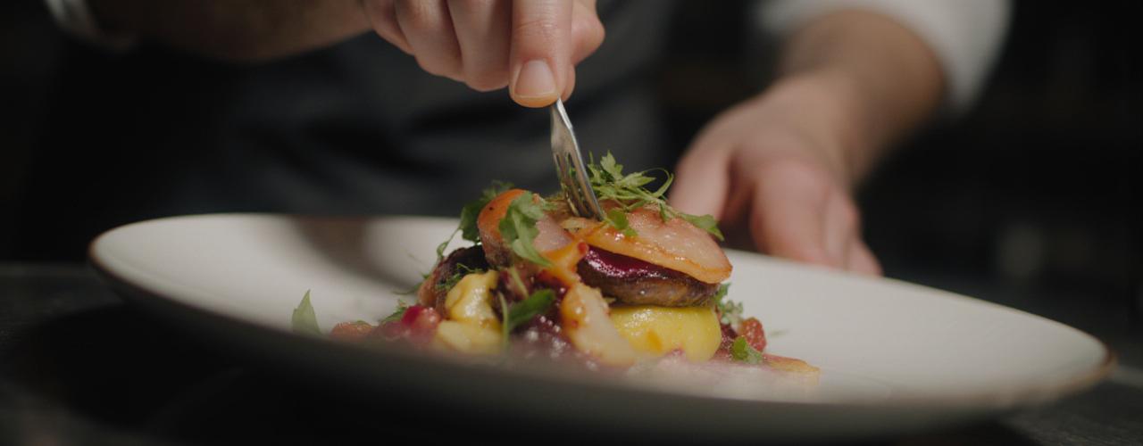Chef preparing a dish representing digital menus