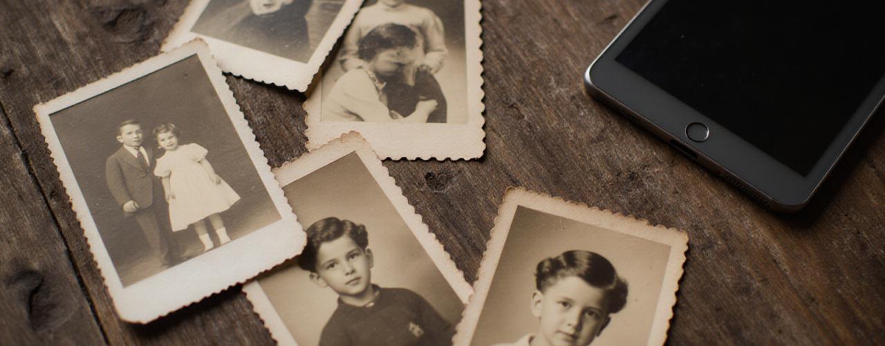 Hands holding old family photographs